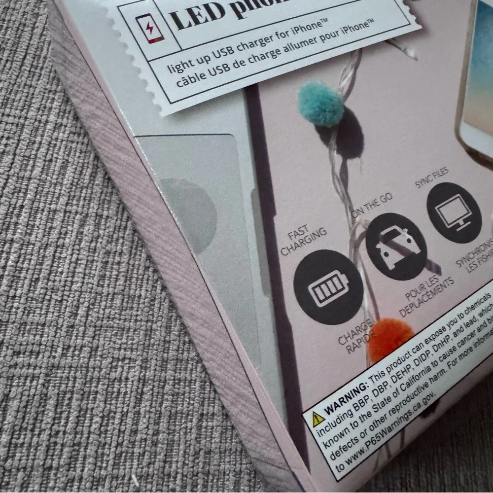 NWT LED phone charger with multicolored Pom-poms